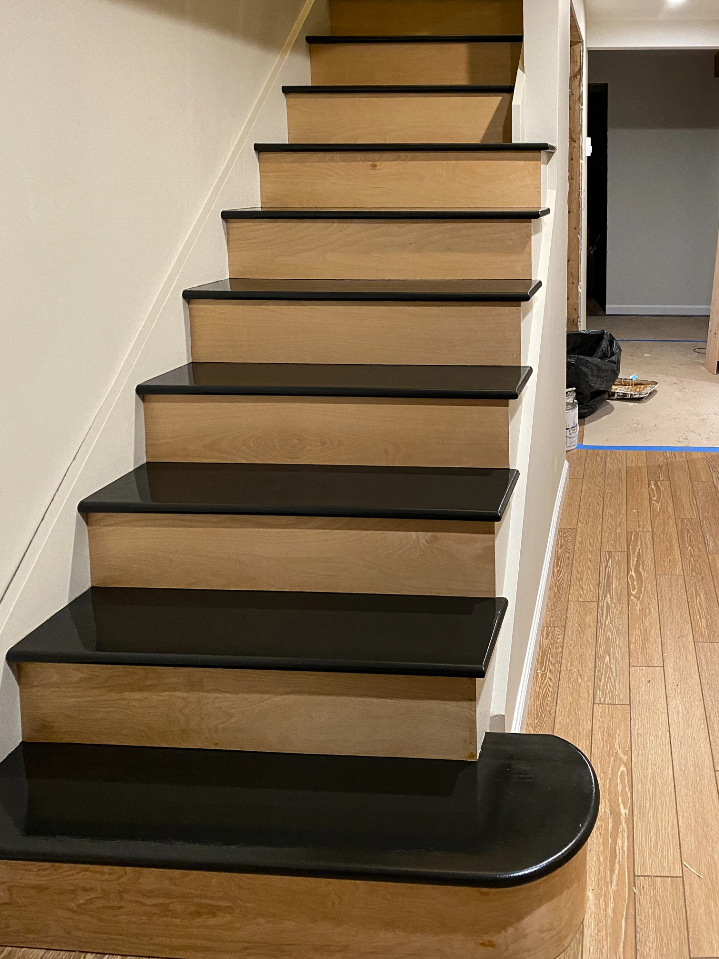 Finished staircase with light oak treads and black risers