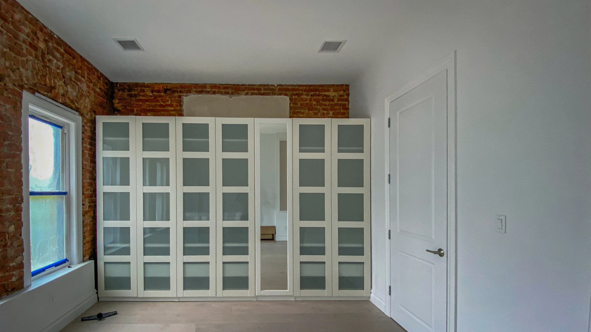 Built in wardrobe wall seen across the finished room