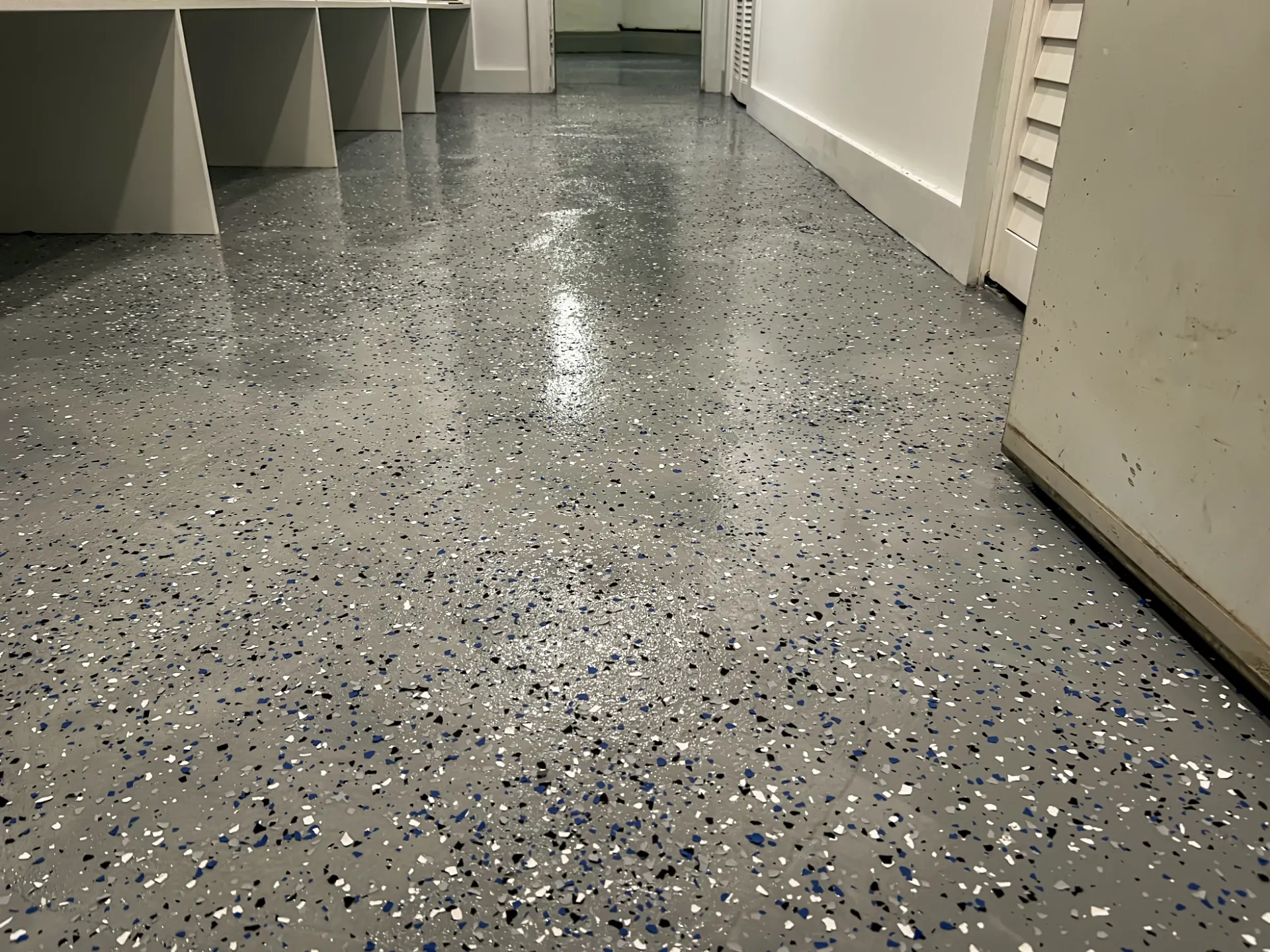 Polished speckled floor with white partition walls