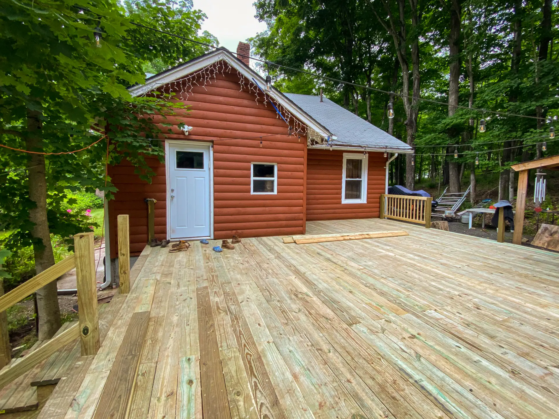 New deck boards laid and finished at the back of a cabin